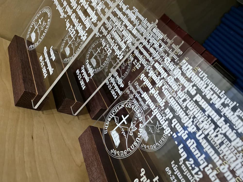 Row of engraved clear acrylic awards mounted on wooden bases