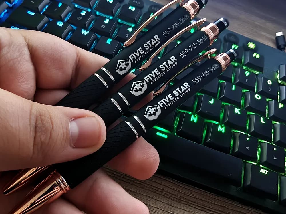 Black metal pens laser-engraved with the Five Star Assisted Living logo