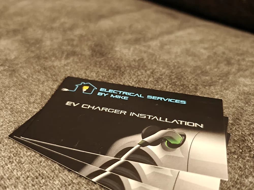Dark brown business cards advertising EV charger installation