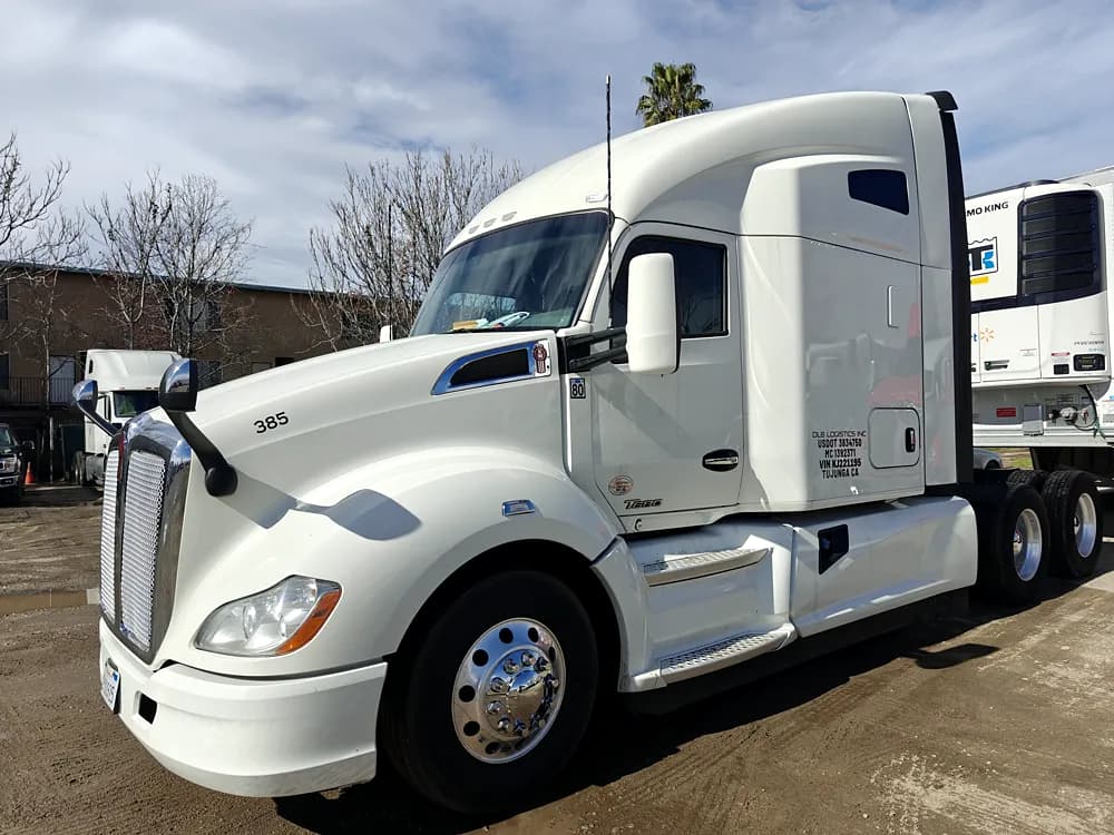 Kenworth semi tractor with cut-vinyl cab door lettering and regulatory numbers