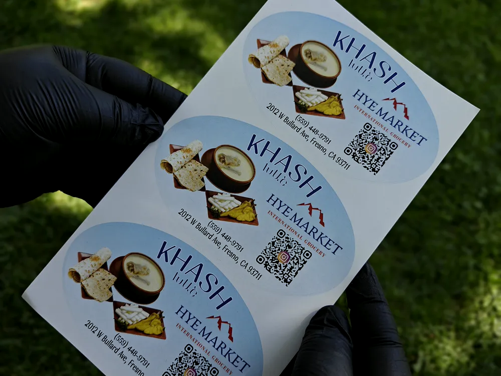 Printed product labels with food photography and a QR code for Khash Hut