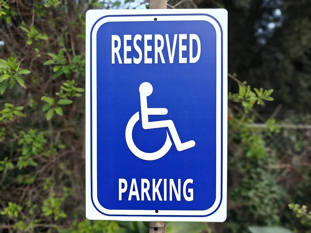 Blue and white reflective aluminium accessible parking sign