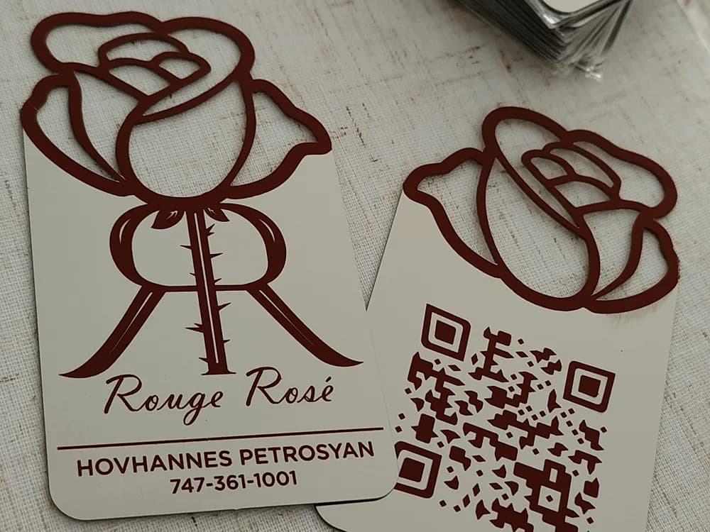 Laser-cut wooden rose motifs and a QR code panel for Rouge Rosé