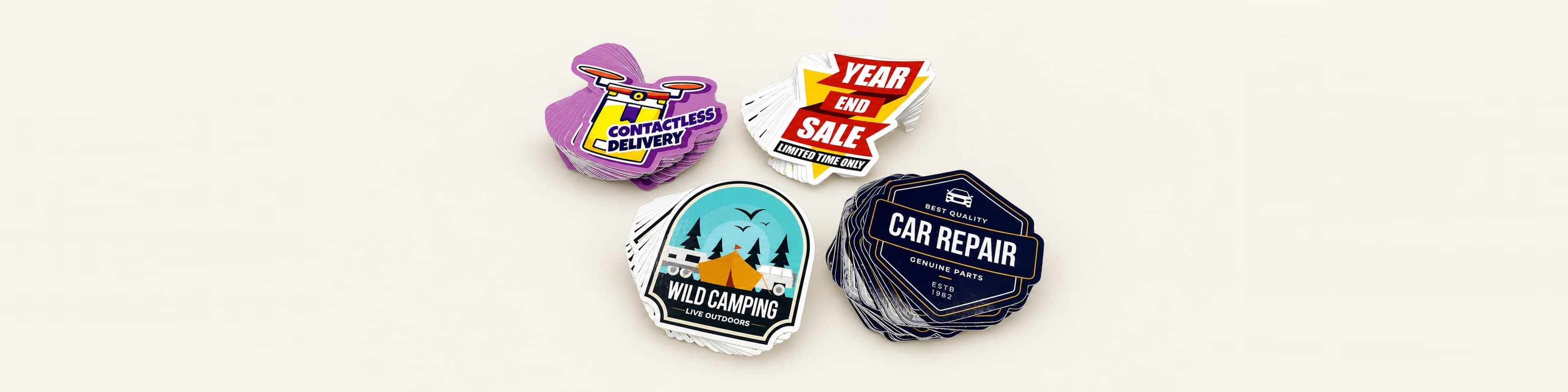 Four stacks of vinyl stickers in different custom shapes, each cut to the outline of its design