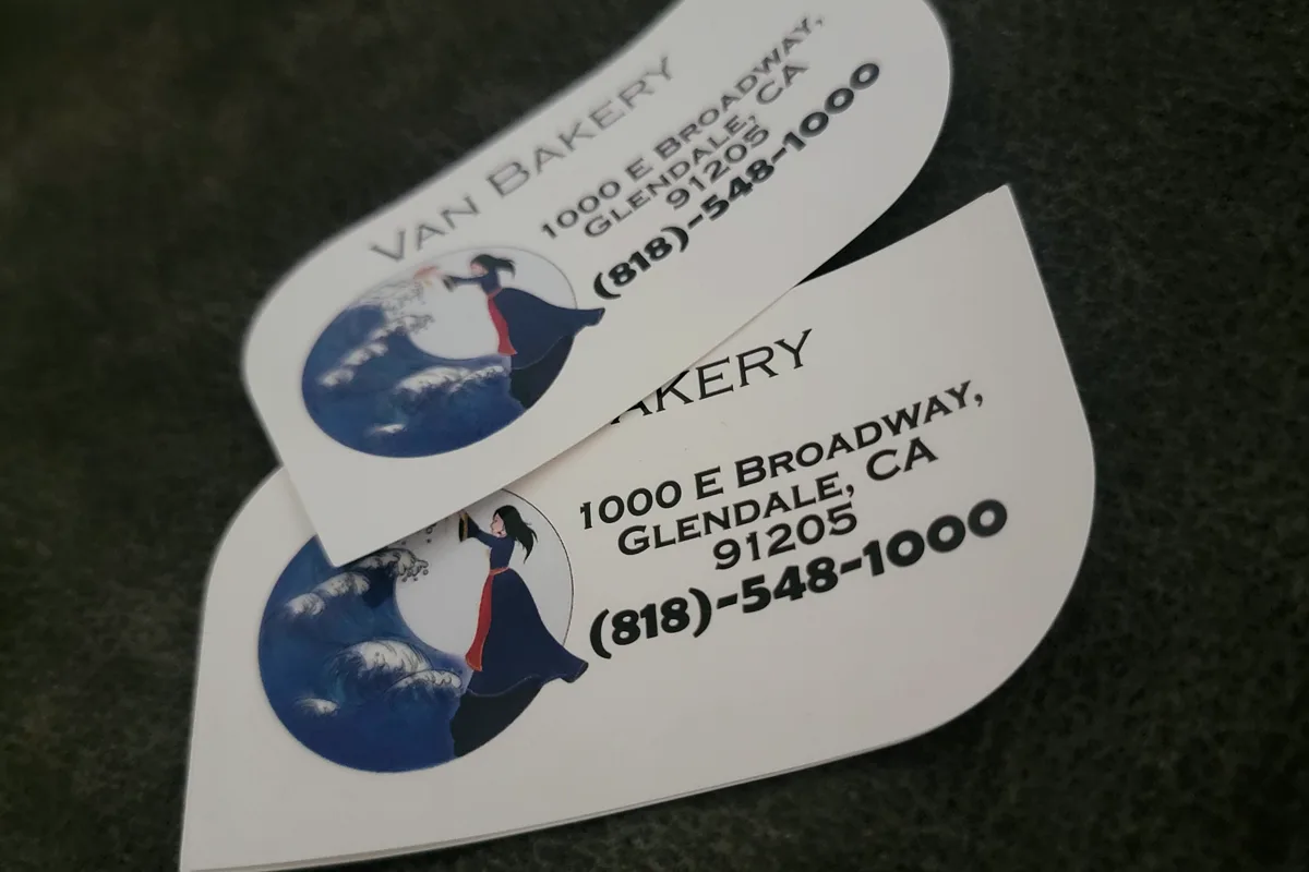 Die-cut business cards with a rounded wave edge for Van Bakery on East Broadway in Glendale